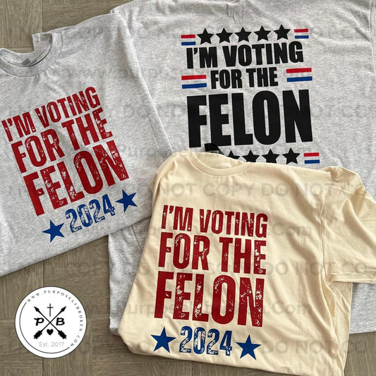 I’m voting for the Felon Shirt ( red design)